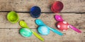 Flatlay, colorful easter eggs, egg dyes and spoons on wooden table