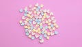 Flatlay colorful marshmallows on sweet pink background with copy space