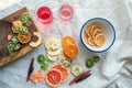 Flatlay of dried fruits slices, fruit candy rolls and two glasses of vitamin water on linen cloth Royalty Free Stock Photo