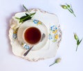 Flatlay with elegant tea set surrounded by flowers Royalty Free Stock Photo