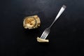 Flatlay of fermented soy tofu yuba leather with spices in a jar and on a fork on a black slate background. East Asian cuisine.