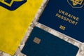 Flatlay, the flag of Ukraine with the coat of arms, a bank card and a passport of a citizen of Ukraine on a light gray