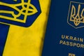 Ukraine, Chernihiv, July 5, 2023: Flatlay, flag of Ukraine with coat of arms and passport of citizen of Ukraine on light