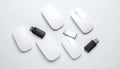 Flatlay of four white computer mice and three black USB flash dr Royalty Free Stock Photo