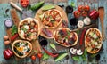 Flatlay of freshly prerared delicious Italian style pizzas. Five