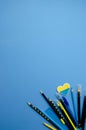 Flatlay horizontal composition with a blue background, a letter board in a wooden frame with the phrase NO WAR and small hearts,F