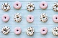 Flatlay of Many Pink and White Donuts on Light Blue Table Royalty Free Stock Photo