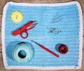 Flatlay, material vor handiwork, crochet hook, scissors, yarn an