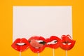 Flatlay overhead on top of white paper photo stand props lips yellow background with copy space