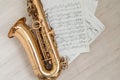 Flatlay picture of the saxophone laying on the note sheets