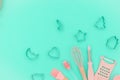 Flatlay pink kitchen utensils on neo mint background. Greater, whisk and iron cooking form. Top horizontal view copyspace love