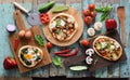 Flatlay of pizza party. Homemade pizzas and raw vegetables in ab