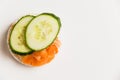 Flatlay, sandwich with cucumber and red fish on a white background