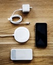 Flatlay of smartphone accessories on wooden table