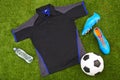 Flatlay of sportswear or trendy soccer clothes, accessories and equipment on grass background. above view of modern