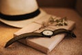 Flatlay of summer straw hat, retro hand watches and a book. Traveler items, vacation travel accessories, holiday weekend, day off Royalty Free Stock Photo