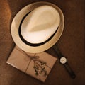 Flatlay of summer straw hat, retro hand watches and a book. Traveler items, vacation travel accessories, holiday weekend, day off Royalty Free Stock Photo