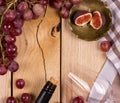 Bottle of wine with cork, glass, red grapes and figs on the table. View from above. Royalty Free Stock Photo