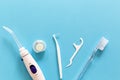 Flatlay of toothbrush, dental floss, irrigator and other hygiene tools on a blue background with copy space for your text. Royalty Free Stock Photo