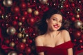 Flatlay top photo of joyful pretty girl lying on red baubles background enjoy dream wish christmas discounts gifts