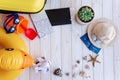 Flatlay Travel Top View. On white wooden background lie plane tickets, passports, map, seashells, yellow suitcase, inflatable Royalty Free Stock Photo