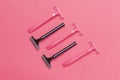 Skin Care Ideas. Flatlay Upper View Image of Five Colorful Pink and Black Disposable Razors Shavers Placed Reversed Over Trendy