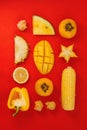 Flatlay of various yellow and orange fruits and vegetables