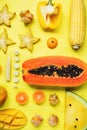 Flatlay of various yellow and orange fruits and vegetables