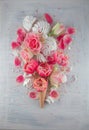 Flatlay waffle sweet ice cream cone with pink tulips and roses blossom flowers over white wood background, top view Royalty Free Stock Photo