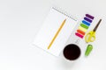 Stationery, notebook, pencil, stapler, scissors, stickers and a cup of tea or coffee