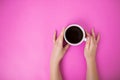 Flatlay with woman holding coffee mug with both hands.