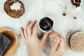 Flatlay of woman`s hands preparing homemade charcoal soap with the ingredients on the side Royalty Free Stock Photo