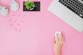 Flatlay with women`s office desk on a pink background.