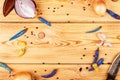 Flatlay wooden background with vegetables, blue pepper, hunting knife