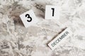 Flatlay wooden calendar with the date December 31 on a white textured background. New Year's holiday is coming soon. Royalty Free Stock Photo