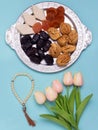 Flatley with rosaries, sweets, dates and tulips. The Concept Of Ramadan