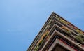 Flats built in post-war Brutalist style architecture at The Barbican in the City of London UK, with colourful flowers on the balco Royalty Free Stock Photo