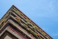 Flats built in post-war Brutalist style architecture at The Barbican in the City of London UK, with colourful flowers on the balco Royalty Free Stock Photo