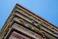 Flats built in post-war Brutalist style architecture at The Barbican in the City of London UK, with colourful flowers on the balco Royalty Free Stock Photo