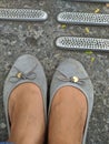 flatshoes gray worn by a woman Royalty Free Stock Photo