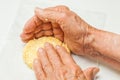 Flatten the dough balls to form the arepa typical shape