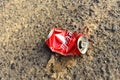 Flattened Coca-Cola can on the ground. Discarded disposable Coca Cola can. Crumpled empty single use Fizzy Drink Coke can. Problem