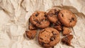 Flatview of handcrafted chocolate cookies with chocolate chips on baking paper