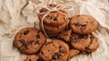 Flatview of handcrafted chocolate cookies with chocolate chips on baking paper