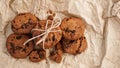 Flatview of handcrafted chocolate cookies with chocolate chips on baking paper