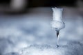 Flavored Grappa Schnapps glass filled with snow in Cortina d`Ampezzo, Dolomites, Italy