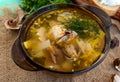 Flavored soup of dried porcini mushrooms in a glass tureen. Royalty Free Stock Photo