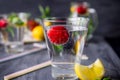 Flavored water with fresh strawberries and mint in glass on a black wooden table with bright details.Selective focus, close up Royalty Free Stock Photo