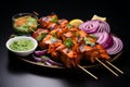 Flavorful charmers Indian chicken tikka kebabs, roasted, accompanied by chutney and onions