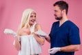 Flawless face of young beautiful blonde long hair patient woman and doctor surgery consulting about breast augmentation